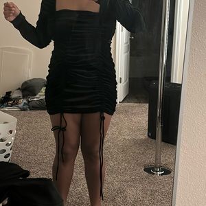 Super cute black scrunchy dress with square-neck and ties at the bottom.